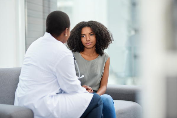 Shot of a young woman having a consultation with a doctor