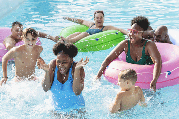 Group of people swimming and tubing in a pool